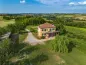 Preview: Rustic dream home in Italy – 3,000 m² surrounded by greenery with panoramic views, aerial view of the house and rolling hills.