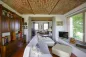 Preview: Rustic dream home in Italy – 3,000 m² surrounded by greenery with panoramic views, living room with sofa, bookcase and brick ceiling.