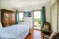 Preview: Rustic dream home in Italy – 3,000 m² surrounded by greenery with panoramic views, bedroom with balcony and hillside view.