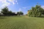 Preview: Rustic dream home in Italy – 3,000 m² surrounded by greenery with panoramic views, large garden lawn with outbuilding and willow tree.