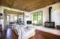 Preview: Rustic dream home in Italy – 3,000 m² surrounded by greenery with panoramic views, living room with fireplace, sofa and brick ceiling.