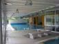 Preview: Piscina interna riscaldata del residence con zona relax e vetrate panoramiche